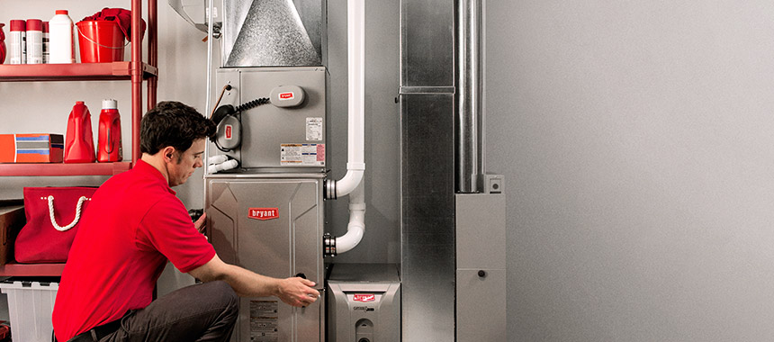 Bryant technician servicing a furnace