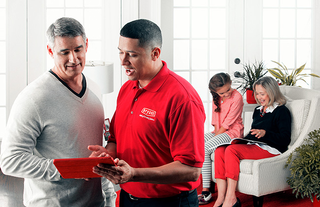 Bryant technician discussing air quality improvement options with the homeowner