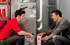 Bryant technician installing a furnace with the homeowner